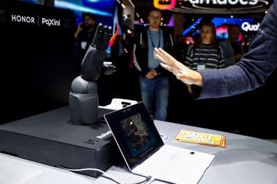 Moški se igra z bionično roko, ki sta jo razvila Honor in Paxini. 