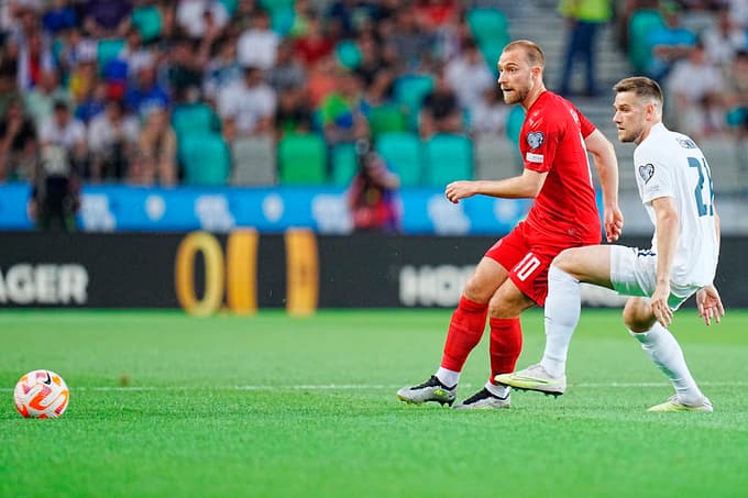 epa10700641 Denmarks Christian Eriksen (C) in action against Timi Max Elsnik of Slovenia (R) during the Euro 2024 group H qualifying soccer match between Slovenia and Denmark in Ljubljana, Slovenia, 19 June 2023. EPA/Liselotte Sabroe DENMARK OUT