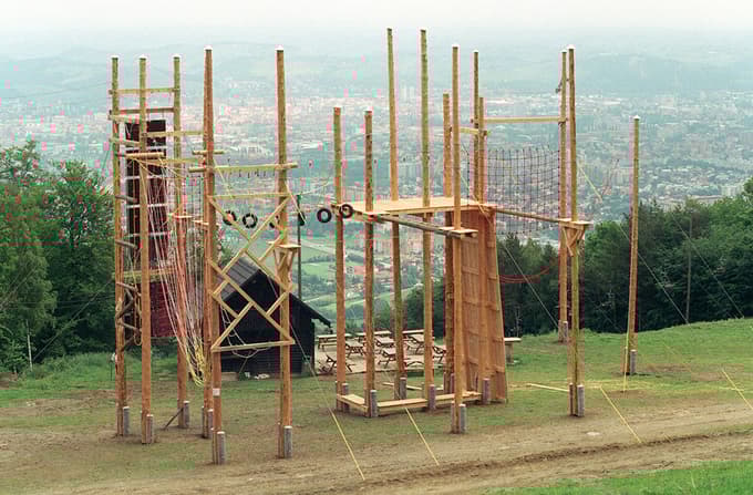 Fotografija je iz leta 2002, ko je na Trikotni jasi ob adrenalinskem parku stala manjša lesena hiša.