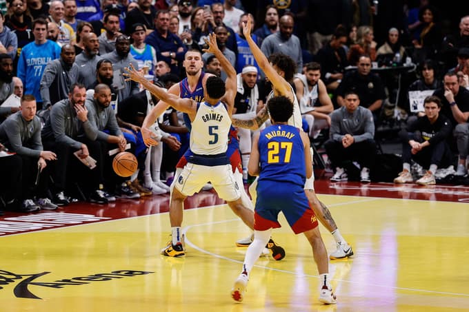 Nov 22, 2024; Denver, Colorado, USA; Denver Nuggets center Nikola Jokic (15) passes the ball to guard Jamal Murray (27) as Dallas Mavericks guard Quentin Grimes (5) and center Dereck Lively II (2) guard in the fourth quarter at Ball Arena. Mandatory Credit: Isaiah J. Downing-Imagn Images