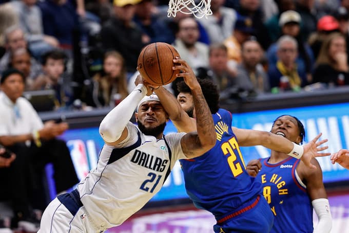 Nov 22, 2024; Denver, Colorado, USA; Dallas Mavericks center Daniel Gafford (21) drives to the net against Denver Nuggets guard Jamal Murray (27) in the fourth quarter at Ball Arena. Mandatory Credit: Isaiah J. Downing-Imagn Images
