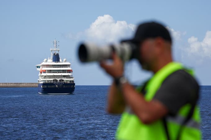 A member of the media works near the cruise ship MV Hondius, affected by a hantavirus outbreak, at the port of Granadilla de Abona, Tenerife, Spain, May 11, 2026. REUTERS/Pedro Nunes