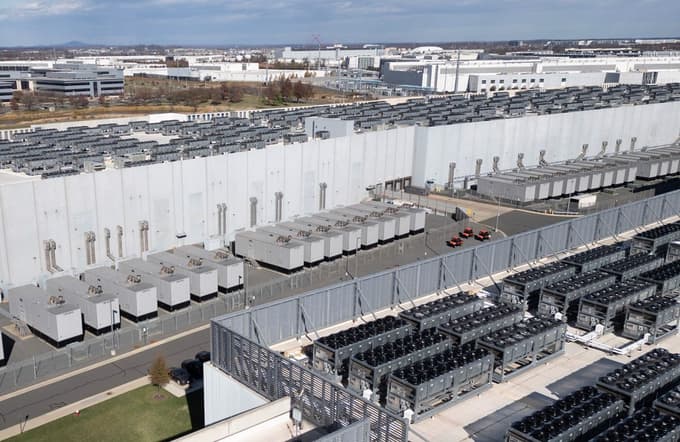 An aerial view shows cooling vent fans on the roof next to generators on the lower level of a Digital Realty data center in Ashburn, Virginia on November 12, 2025. Data centers are the physical infrastructure that make our digital lives possible, yet most people have never seen one up close or understand how they operate. Roughly 12,000 data centers are in operation in the world, with about half in the US, according to Cloudscene, a data center directory.,Image: 1057819058, License: Rights-managed, Restrictions: TO GO WITH AFP STORY by Alex PIGMAN: "Data centers: a view from the inside", Model Release: no