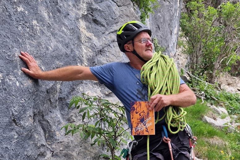 Tomaž Žganjar z Zaplezanimi zgodbami, prvo žepno knjigo Planinske založbe, pod steno Bele peči 