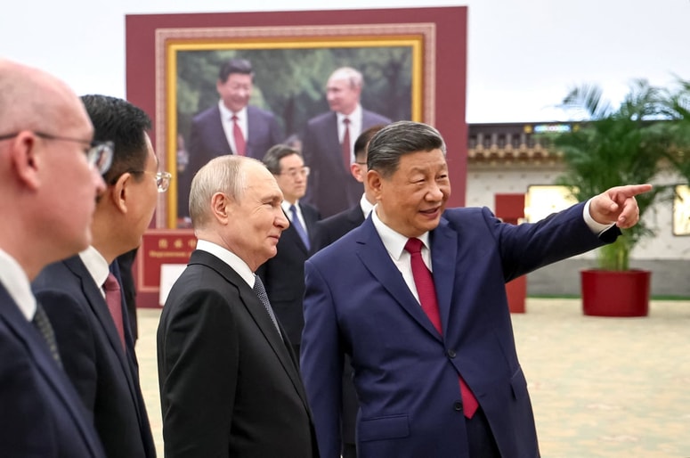 Russian President Vladimir Putin and Chinese President Xi Jinping tour a photo exhibition by the TASS and Xinhua news agencies at the Great Hall of the People in Beijing, China May 20, 2026. Sputnik/Alexander Kazakov/Pool via REUTERS ATTENTION EDITORS - THIS IMAGE WAS PROVIDED BY A THIRD PARTY. 